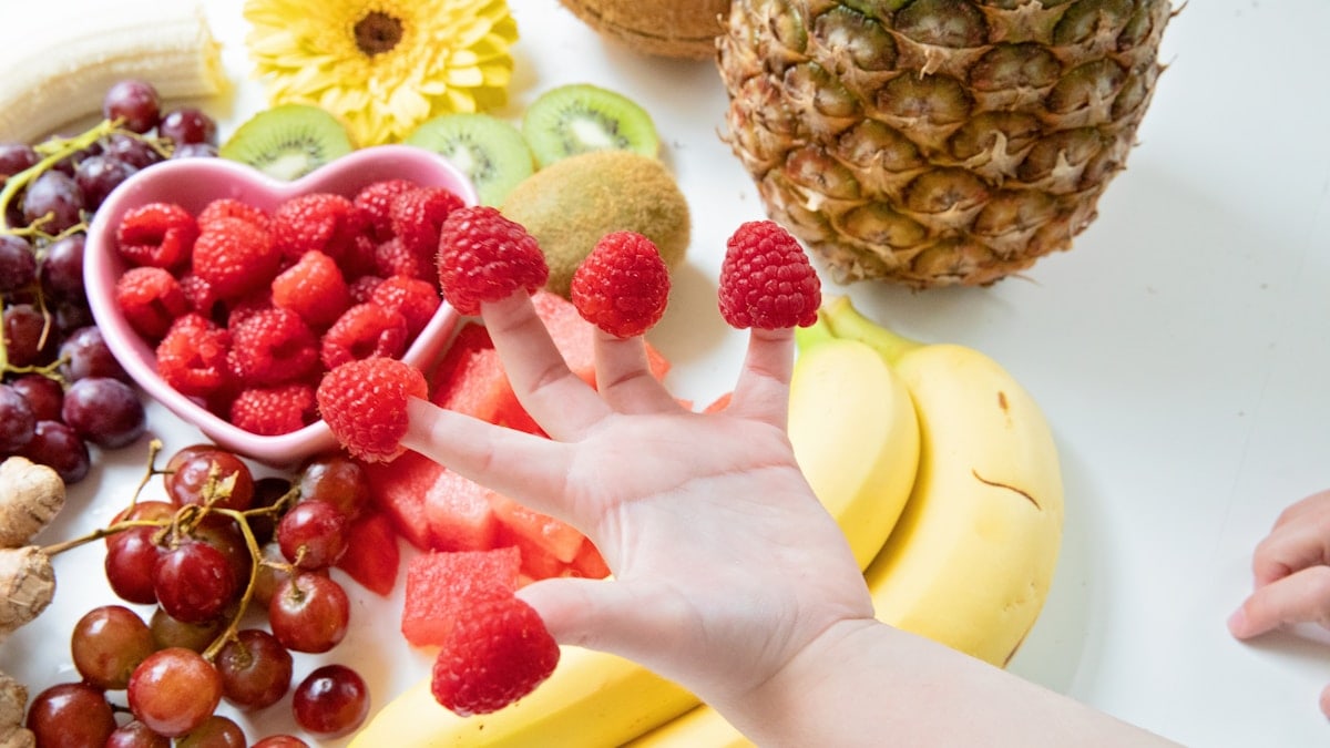 Fruit Raspberries Kiwi Watermelon Flowers Ginger Bananas Pineapple Flatlay raspberry fingers kids hands healthy snack