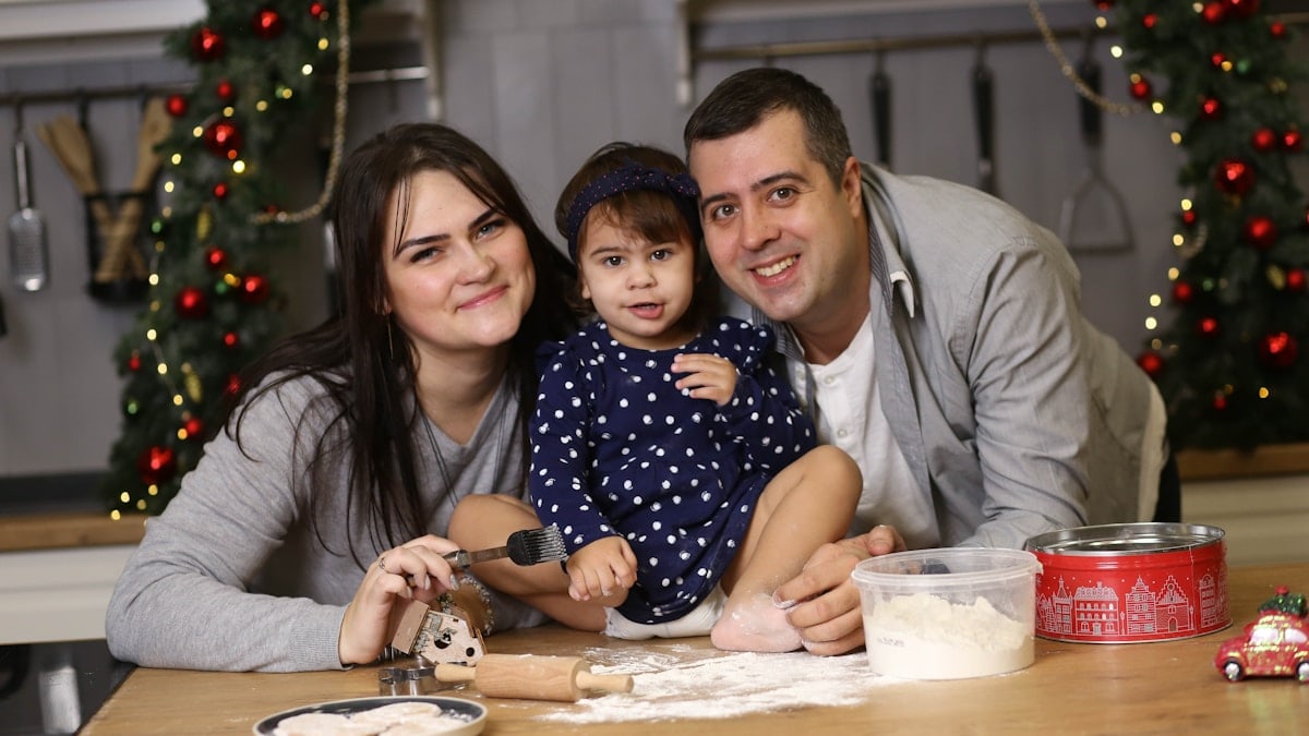 a man, woman and child are sitting at a table